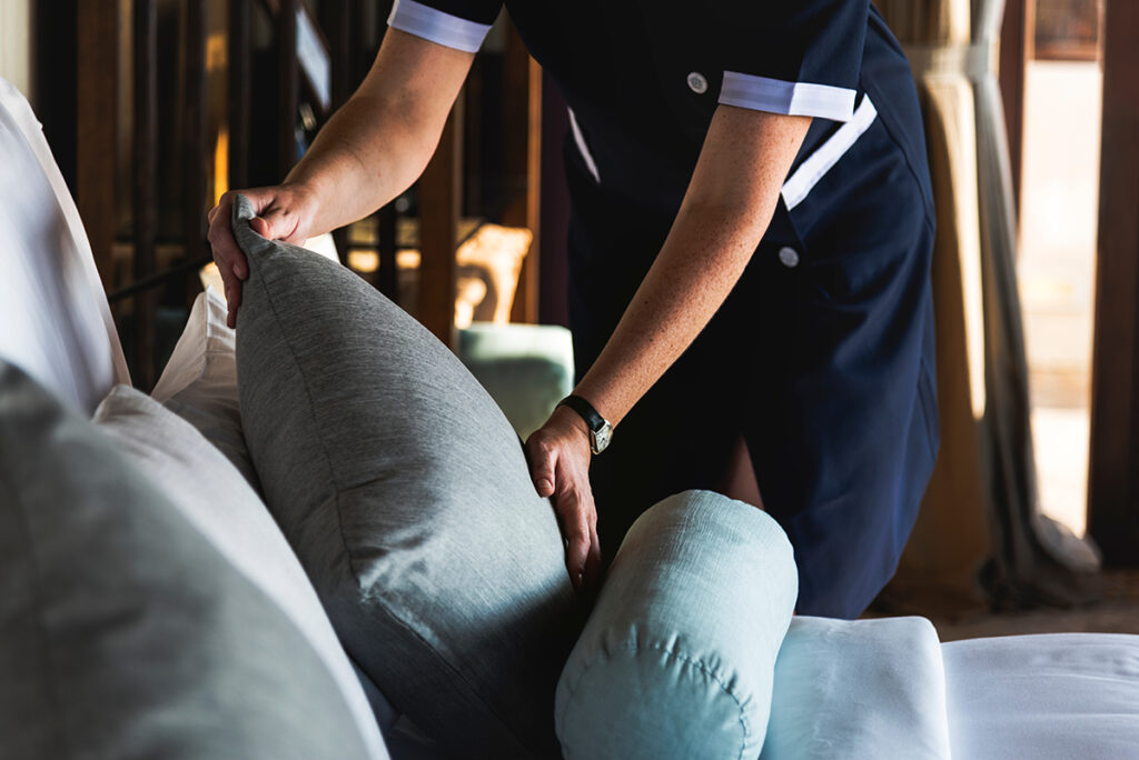 Housekeeper making a bed