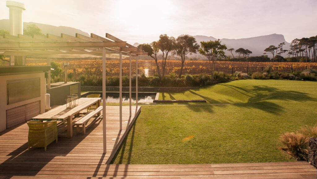 Sunny patio in a yard overlooking the mountains at a luxury estate